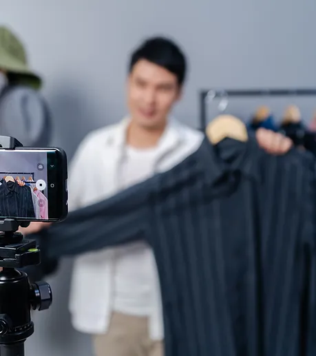 A man selling clothes live